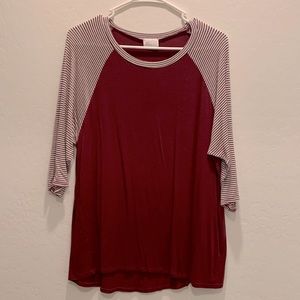 Three quarter length sleeved burgundy top.